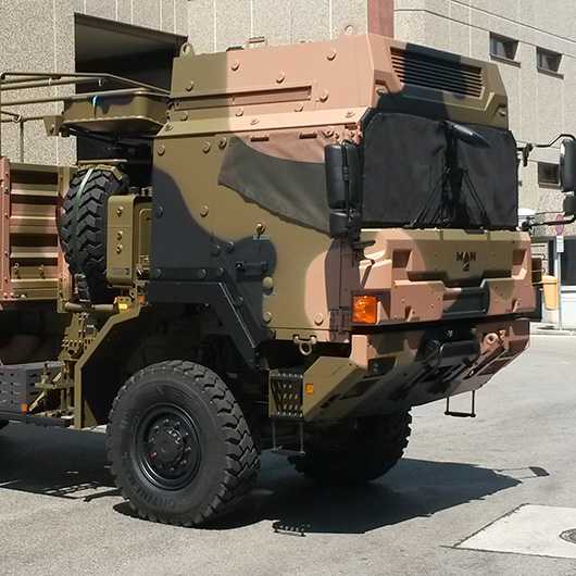 Militärfahrzeug: Technische Konfektion für robuste Militärausrüstung. Tarnfarbenes Nutzfahrzeug.