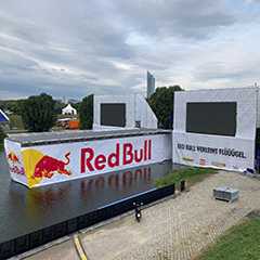 Red Bull Event Outdoor: Gerüst mit Leinwand und LED-Bildschirmen.